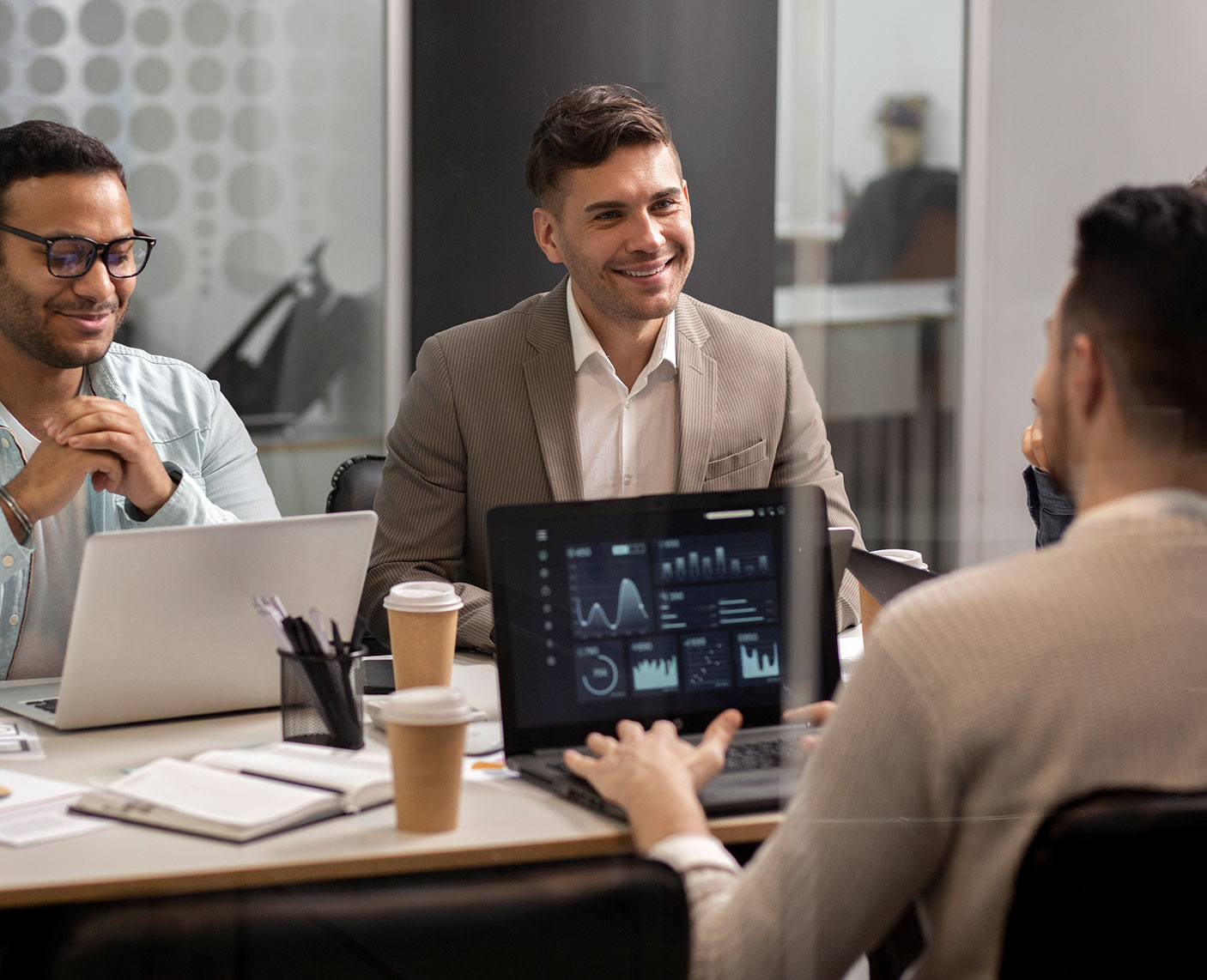 A consultant and business owner reviewing a whiteboard with content pillars and social media platforms, symbolizing strategy alignment and audience focus.